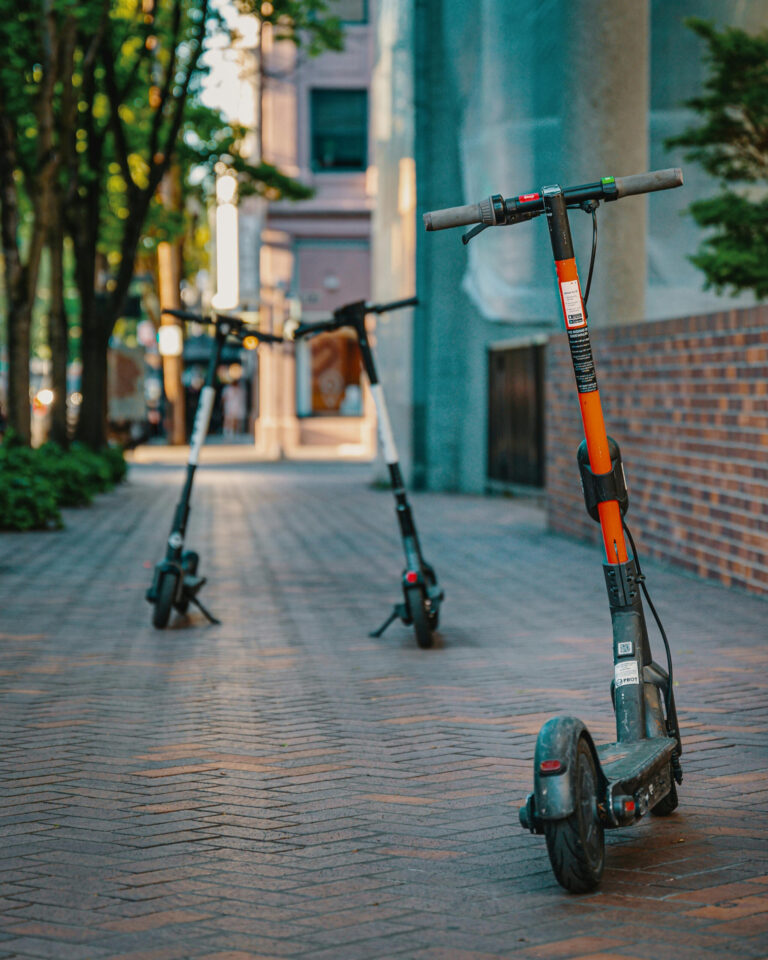 Three e-scooters parked and available for the rental on the campus