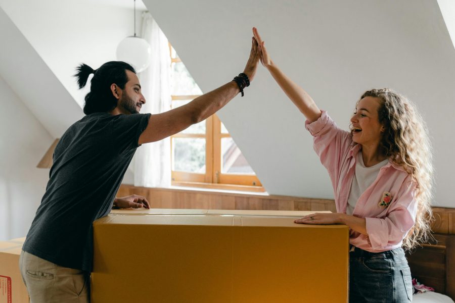 two people hifiving in a new apartment